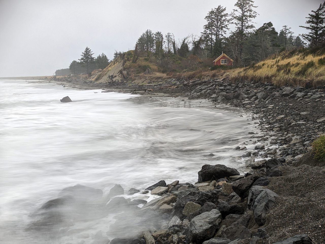 Washington’s seasonal king tides, shown here at Washaway Beach in November 2022, are becoming more destructive as sea levels rise. Local leaders have spread an experimental cobble berm along the shore to help stem erosion